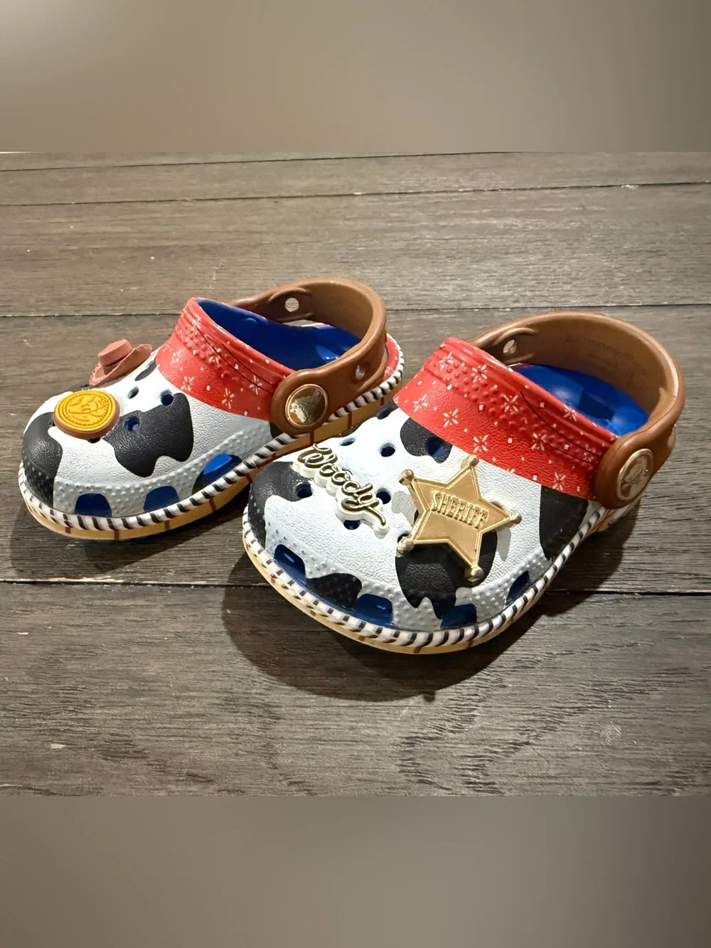 CROCS Kids Cow-Print Clogs with Red Strap and Blue Lining Toy Story Woody